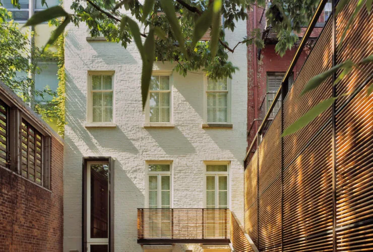 high-screen wall to protect the backyard townhouse patio with rattan furniture