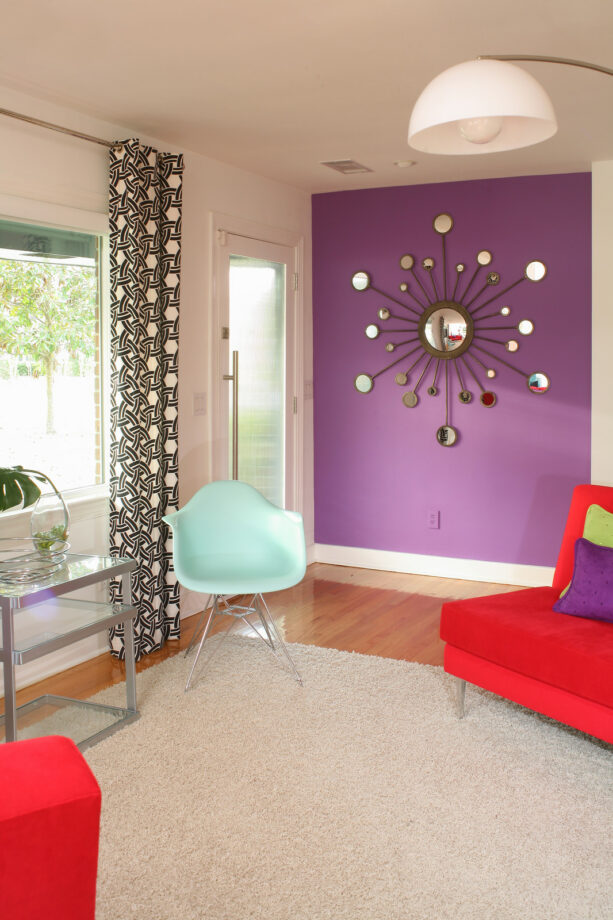 passionate purple - sherwin williams accent wall with a sunburst mirror