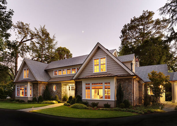 square bay window with white trim against the stone exterior
