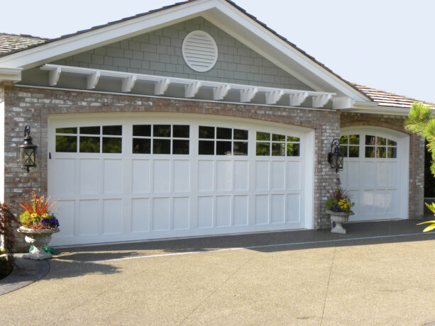 white pergola over carriage style garage doors