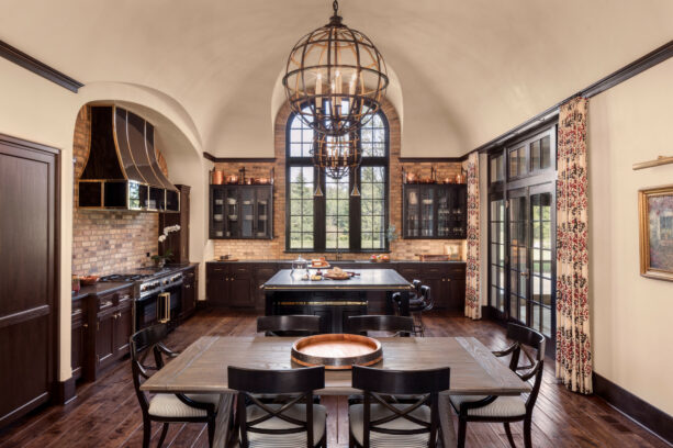 beige-colored backsplash around a huge arched kitchen window