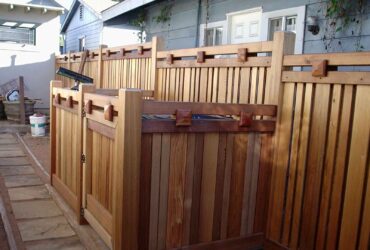 cedar craftsman-style fence with dumpster enclosure
