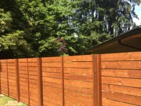 horizontally lain tight knot cedar fence in a mid-century modern style