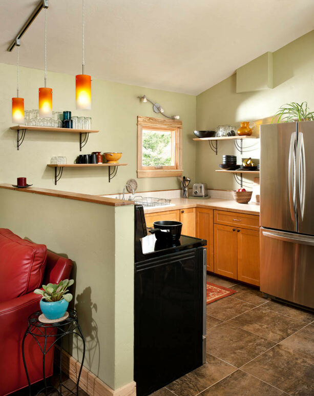 open concept kitchen with a wood-topped pony wall as a border